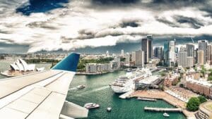 Airplane flying over Sydney. Tourism concept.