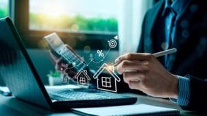 Business man with laptop and drawn houses overlay