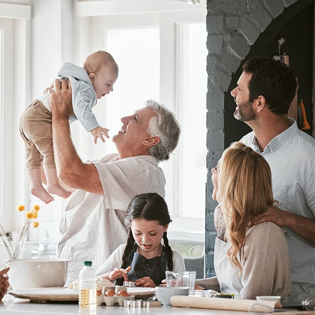 Multi-generation family baking in a modern bright kitchen