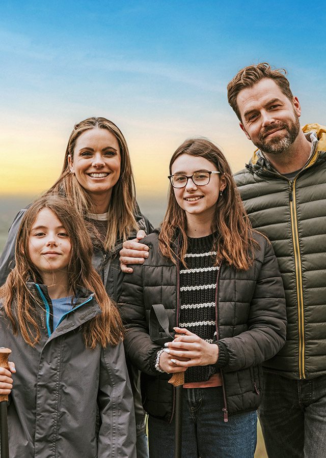 Outdoors family hiking in the hills at sunset