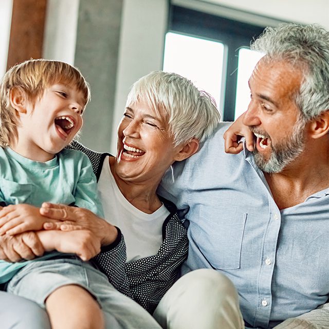 Portrait of grandparents and grandchildren having fun together at home