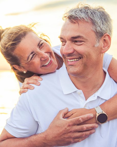 A Happy Romantic Mature Couple Enjoying Sunset on the Beach