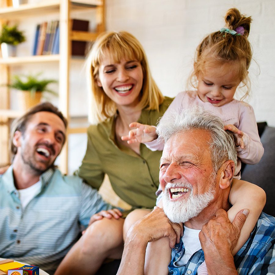 Senior grandparents playing with grandchildren and having fun with family